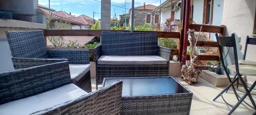 a patio with two chairs and a table on a balcony at Niki House in Ayios Nikolaos Sithonia