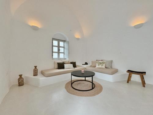 a living room with two beds and a table at as holiday caves in Mesaria
