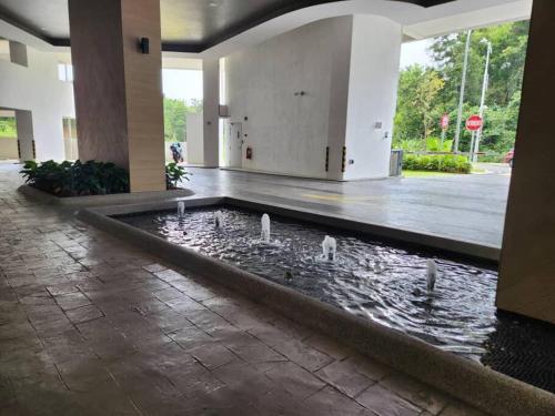 a group of swans swimming in a pond in a building at Antara Lima Homestay Putrajaya in Putrajaya