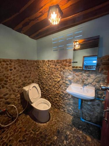 a bathroom with a toilet and a sink at Adventure Point Resort By Sali in Kaeng Krachan