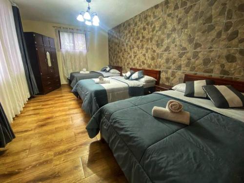 a group of four beds in a room at Cabaña JR in Pititic