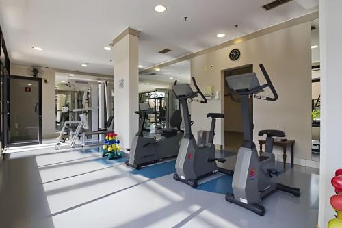 a gym with treadmills and elliptical machines at Airfamily Congonhas in Sao Paulo