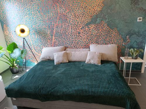 a bedroom with a green bed with a wall mural at Modernes, zentrales Apartment in Troisdorf, Region Köln Bonn, 3 Etage, maximal für 4 Personen, Parkplatz & Netflix inklusive in Troisdorf