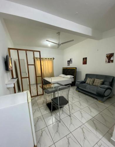 a living room with a couch and a table at Ariosa Apartments in Mtwapa