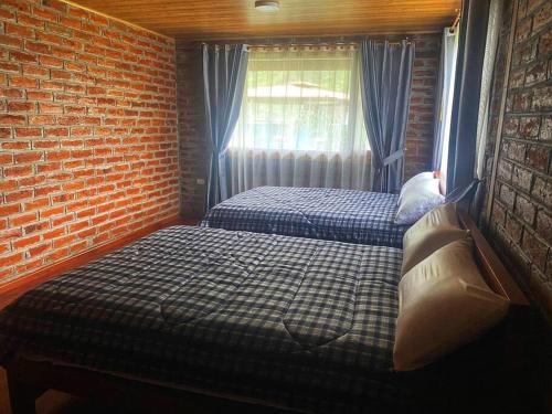 Postel nebo postele na pokoji v ubytování Cabaña Mirador