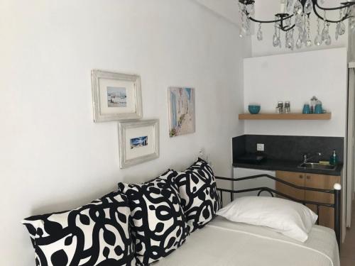 a living room with a couch and a sink at Morpheus Rooms in Kinion