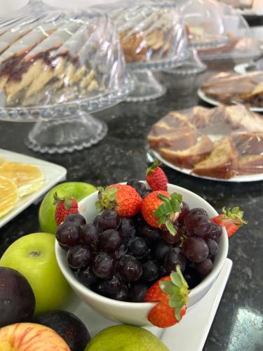 a bowl of fruit on a table with other foods at Nautillus Hotel in Parnaíba