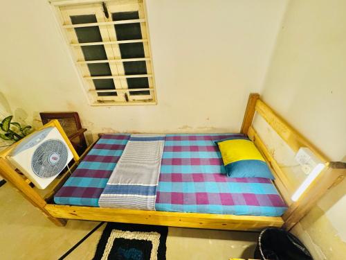 a small bed in a room with a window at Madiha Hostel by Land of Rizka in Matara