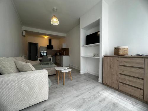 un salon avec un canapé et une table dans l'établissement Appartement cosy hyper centre, à Bar-le-Duc