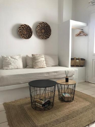 a living room with a couch and two tables at Morpheus Rooms in Kinion