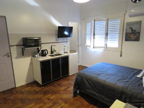 a bedroom with a bed and a sink and a microwave at Ana Rent lll in Boulogne