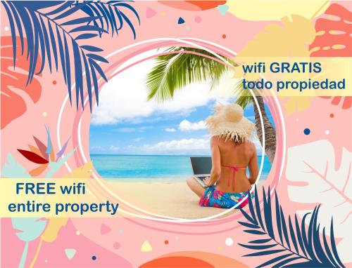 una donna seduta sulla spiaggia con un portatile di CARAIBICO DELUXE Beach Club & SPA a Punta Cana