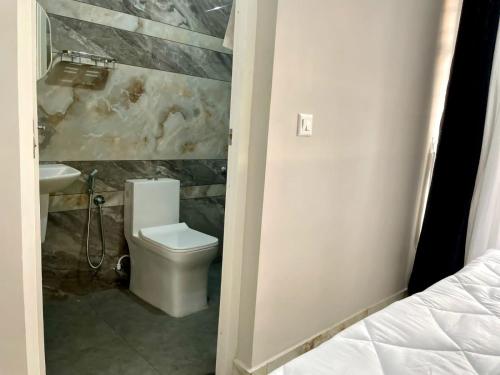 a bathroom with a toilet and a sink at Appartment in Ernakulam