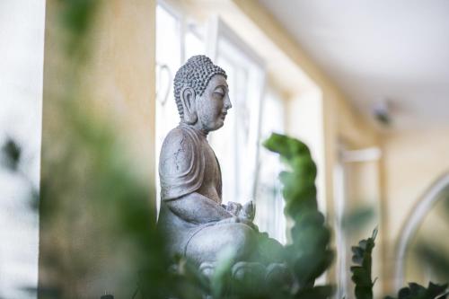 a white statue sitting in front of a window at Alpenaussicht in Obergurgl