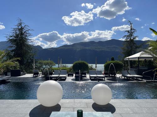 a swimming pool with lounge chairs and a swimming pool at Les Suites du Lac in Aix-les-Bains