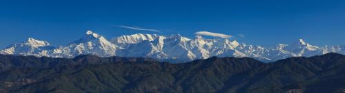 a view of a mountain range with snow covered mountains at Yak and Yeti Inn in Rānīkhet