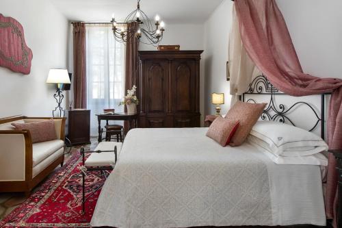 a bedroom with a large bed and a couch at Abbadia San Giorgio in Moneglia