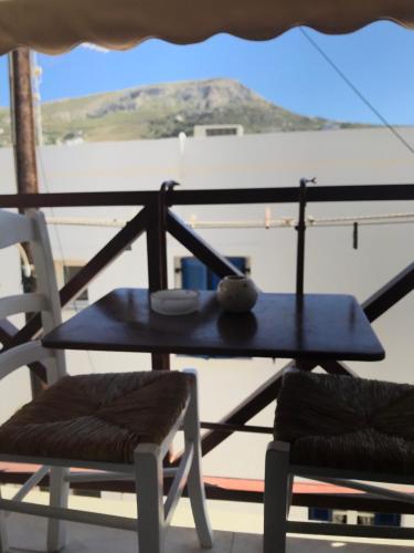 a table and chairs on a balcony with a view at Morpheus Rooms in Kinion