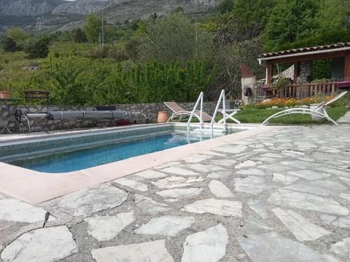 a swimming pool with a fountain in a yard at AlpesAzur in Coursegoules