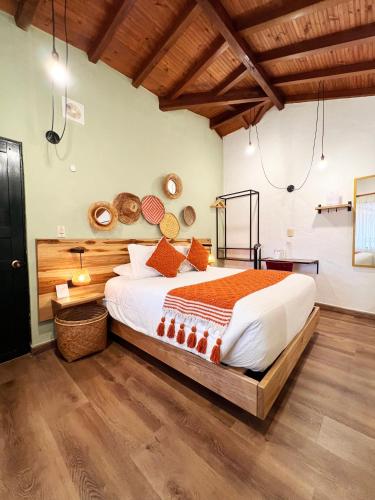 a bedroom with a large bed in a room at Sie Casa Hotel in Villa de Leyva