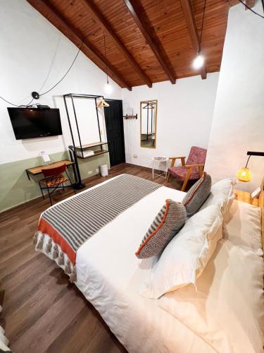 a bedroom with a large bed in a room at Sie Casa Hotel in Villa de Leyva