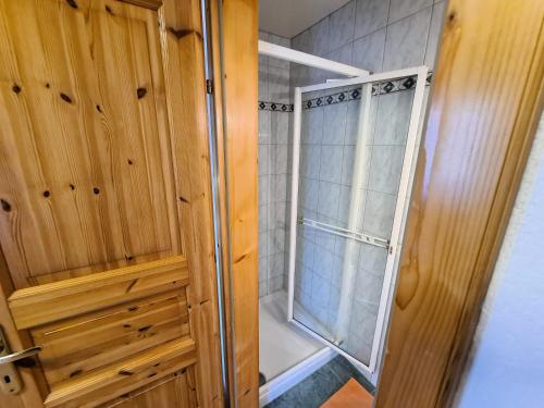 a walk in shower with a glass door at Pension Sydler in Bad Goisern