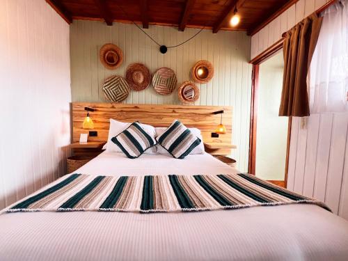 a bedroom with a bed with two pillows at Sie Casa Hotel in Villa de Leyva