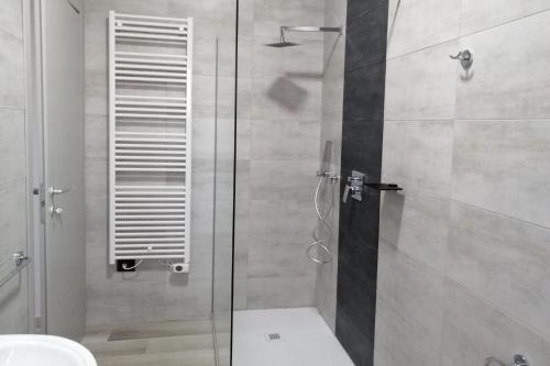 a bathroom with a shower with a glass door at la luna blu malpensa camera singola zen in Somma Lombardo