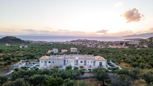 an aerial view of a large white house at Sundy Maria Apartments in Stoupa