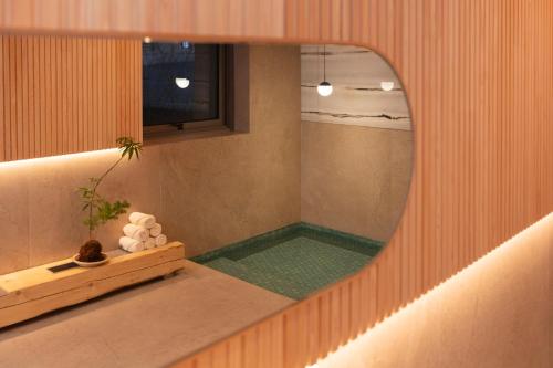 a reflection of a shower in a mirror at PBr7 Hotel Unusual Stay in Gyeongju