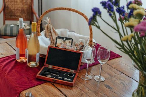 a table with a laptop and wine glasses on it at Studios Kilindra in Astypalaia Town
