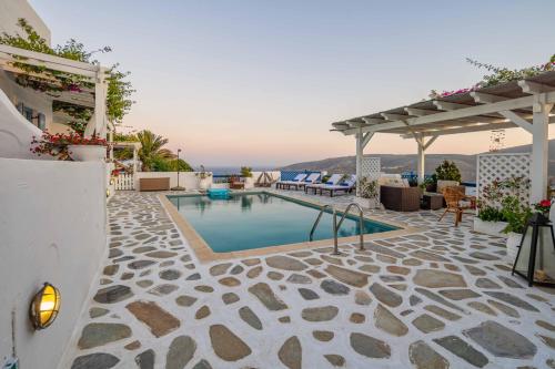 a swimming pool on a house with a patio at Studios Kilindra in Astypalaia Town