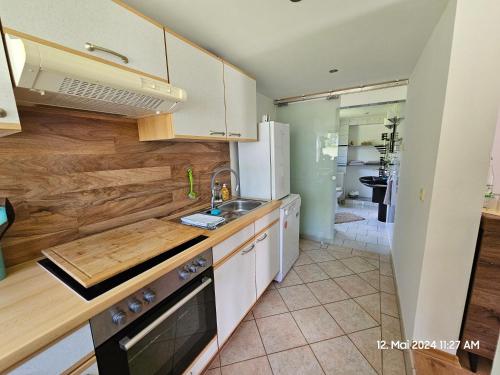 a kitchen with a sink and a refrigerator at Bungalow ,, Zur langen Heide,, in Hildburghausen