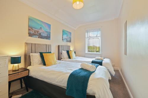 a bedroom with two beds and a desk and a window at HILLTOP PLACE SUITES 4 Bedrooms 6 BEDS for CONTRACTORS near M1J31 FREE PARKING FOR VANS in Killamarsh