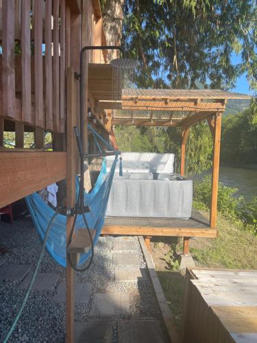 a hammock on a porch of a house at Riverfront Getaway on the Wild and Scenic in Sedro-Woolley
