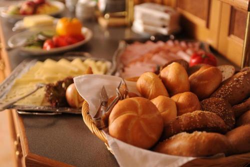 a table topped with a basket of bread and pastries at Landhotel Gressenbauer in Hinterstoder