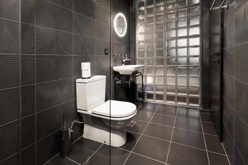 a bathroom with a toilet and a sink at Avangarda Suites in Belgrade