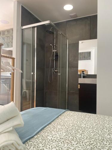 a bathroom with a shower and a bed in a room at Terrace House in Lisbon