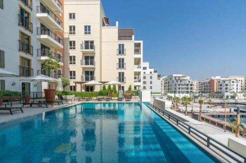 a large swimming pool in front of a building at Beach stylish full sea view in Dubai