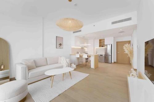 a white living room with a couch and a table at Beach stylish full sea view in Dubai