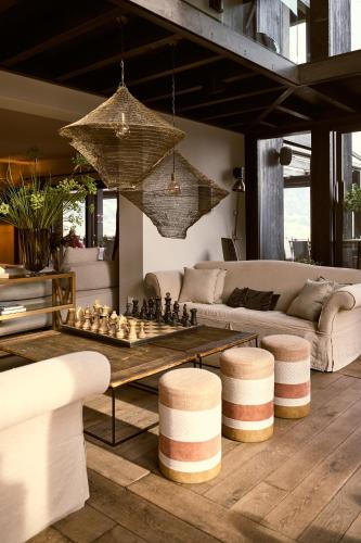 a living room with a chess table and a couch at Hotel KÜGLERHOF in Tirolo