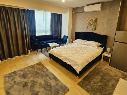 a bedroom with a bed and a couch and a chair at Mamaia Nord - Studio in Mamaia