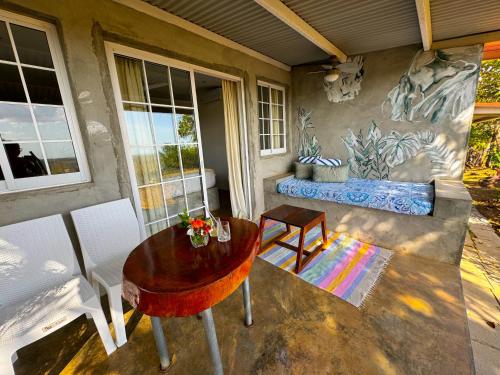 a patio with a table and chairs and a bench at La Maracuya Panama in Playa Coronado
