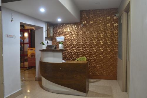 um restaurante com um balcão num quarto com uma parede de tijolos em O'SKY INN em Siliguri