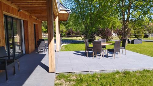 a patio with a table and chairs on it at Casa Adam's in Saint-Jean-le-Thomas