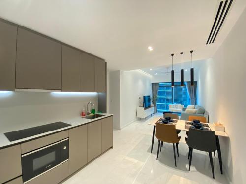 a kitchen and dining room with a table and chairs at Eaton Residences KLCC by Ikon in Kuala Lumpur