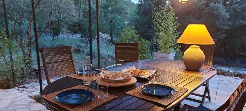 une table en bois avec des assiettes de nourriture dessus dans l'établissement La cachette, à Carcès