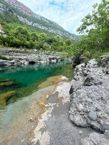 a river with turquoise water in a rocky area at Mini Farm Cemi 