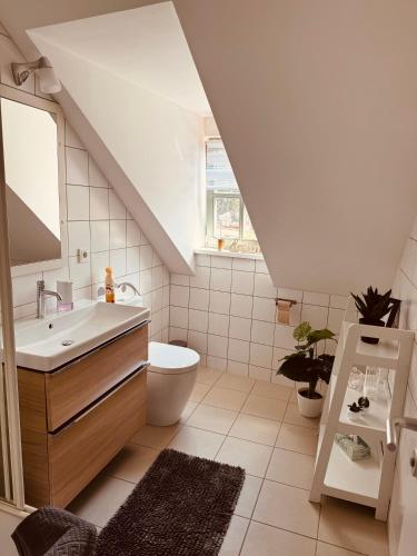 a white bathroom with a sink and a toilet at KM - Altstadtapartments Freiberg in Freiberg