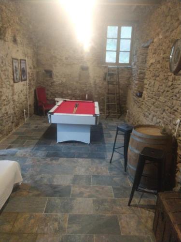 a room with a ping pong table and a barrel at Mas du Roy in Sénéchas